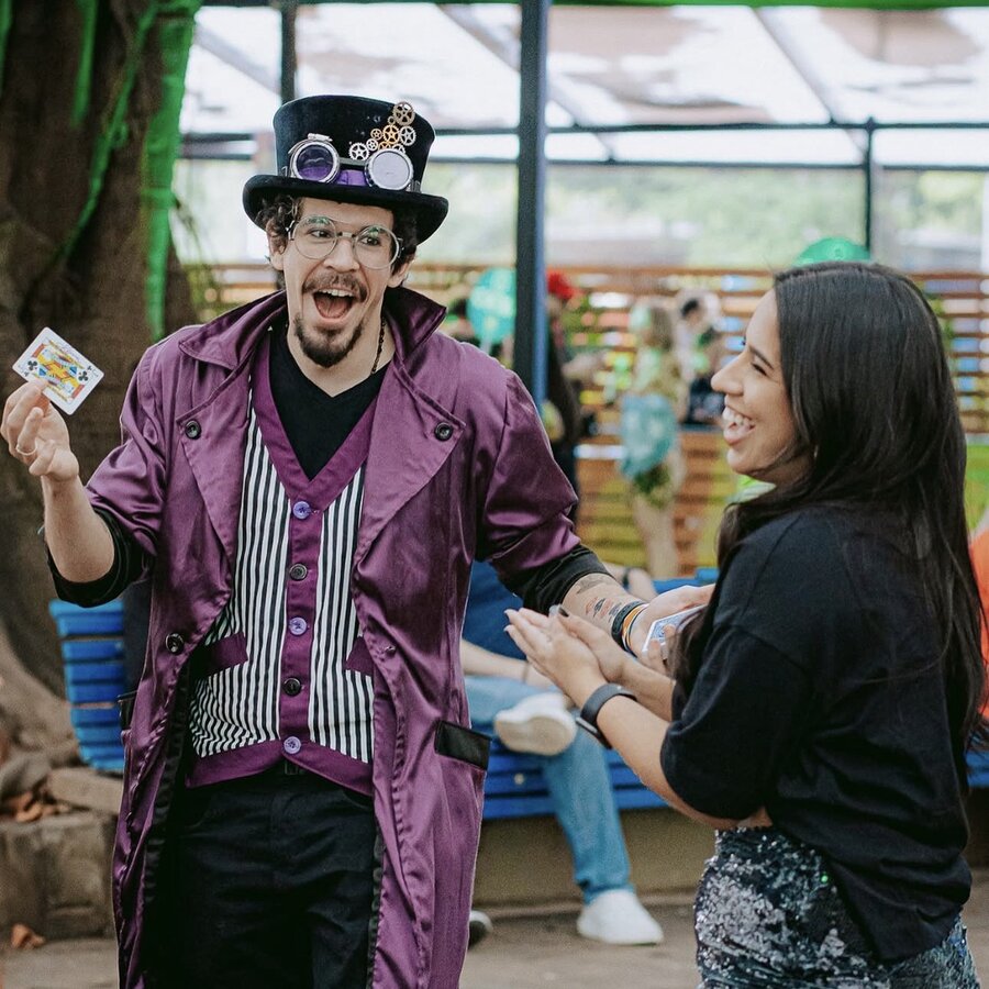 Mulher sorrindo durante mágica com cartas
